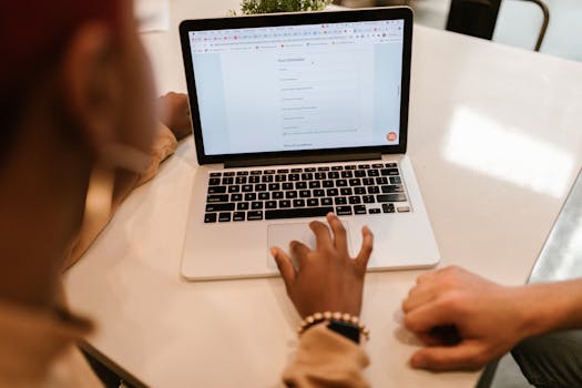 person using tax software on a laptop