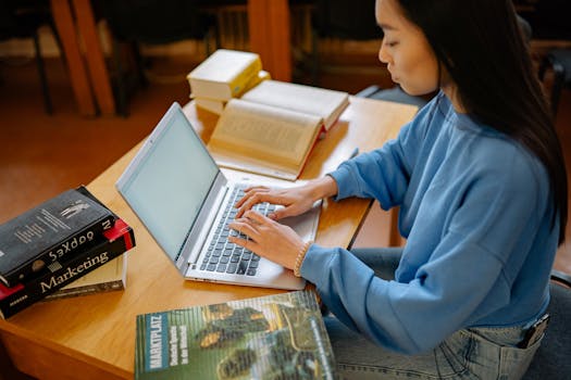 person studying with books and laptop