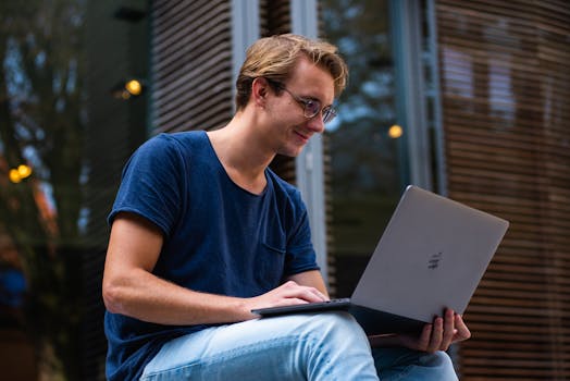 image of a student working on a laptop