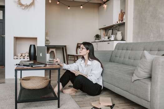 image of a student studying with a laptop and bills