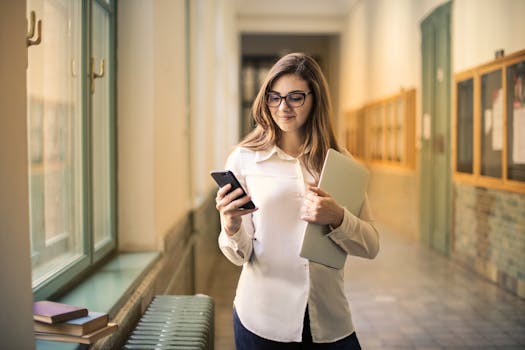 Happy student using a smartphone to manage finances