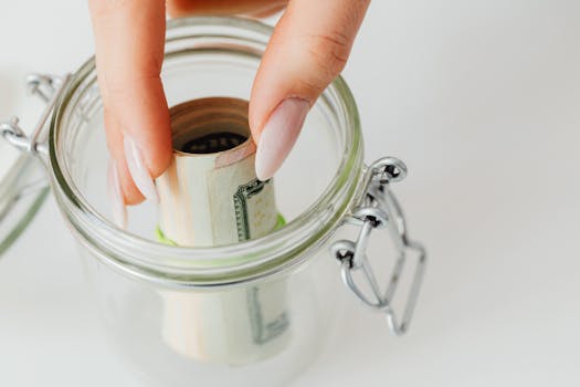 person putting money in a piggy bank