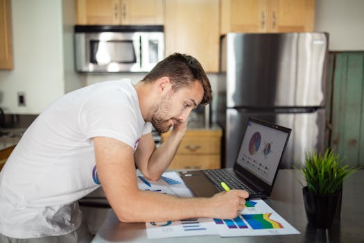 young person reviewing budget on laptop